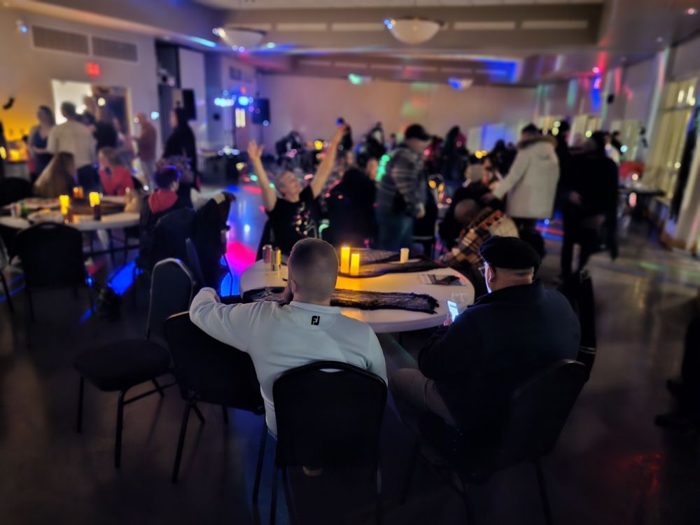 Community celebration night with music and candlelit tables