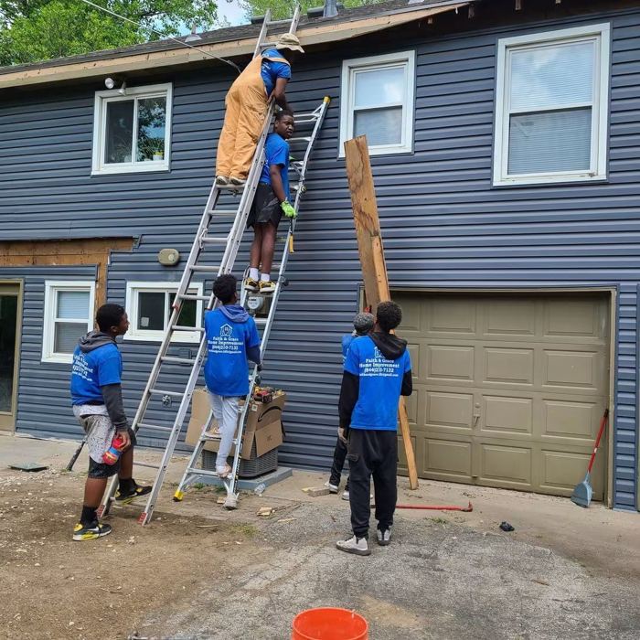 Crew ladders siding rehab hero