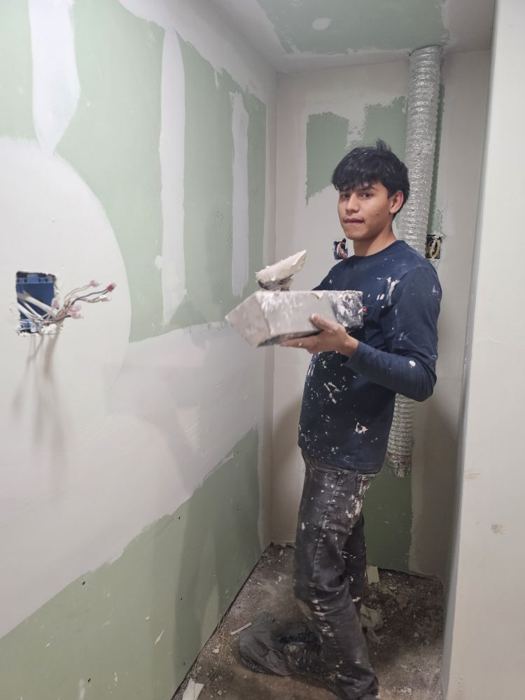 Trainee drywall mudding